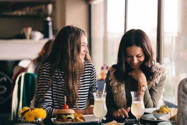 Girlfriends laughing and eating